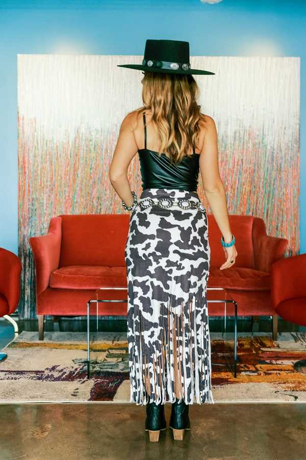 Experience the western trend with our Cow Print Suede Fringe Mermaid Skirt. Made from soft suede and featuring a cow print design, this skirt will add a touch of edgy elegance to your wardrobe. The fringe detailing adds movement and unique style to this versatile mermaid skirt. Perfect for any occasion, from casual to formal.