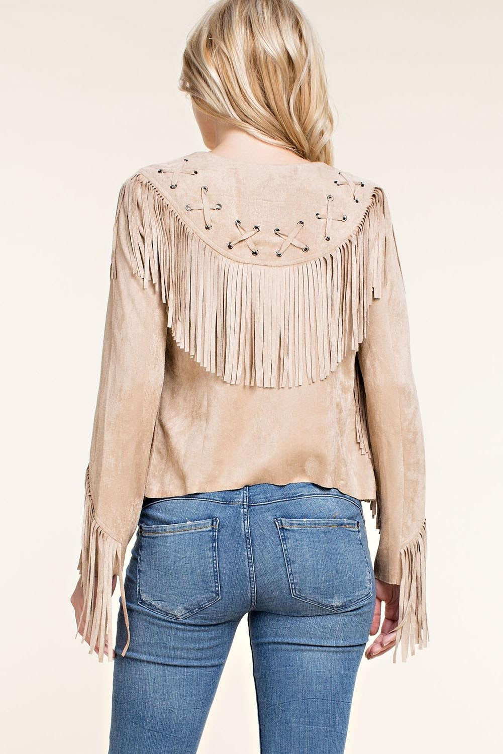 Introducing the Faux Suede Western Fringe Jacket - a stylish addition to any wardrobe. This chic and boho-inspired jacket features long sleeves, open front, whip-stitched back yoke, and fringe details along the trim and sleeves. Its straight back hem and asymmetrical front hem add a touch of urban western flair. Elevate your outfit with this must-have essential from Vocal.