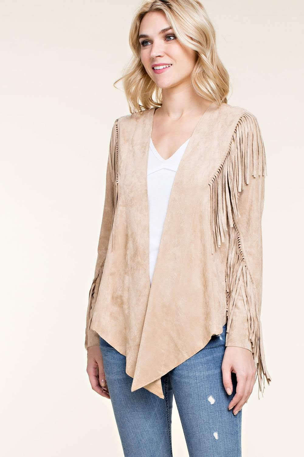 Introducing the Faux Suede Western Fringe Jacket - a stylish addition to any wardrobe. This chic and boho-inspired jacket features long sleeves, open front, whip-stitched back yoke, and fringe details along the trim and sleeves. Its straight back hem and asymmetrical front hem add a touch of urban western flair. Elevate your outfit with this must-have essential from Vocal.
