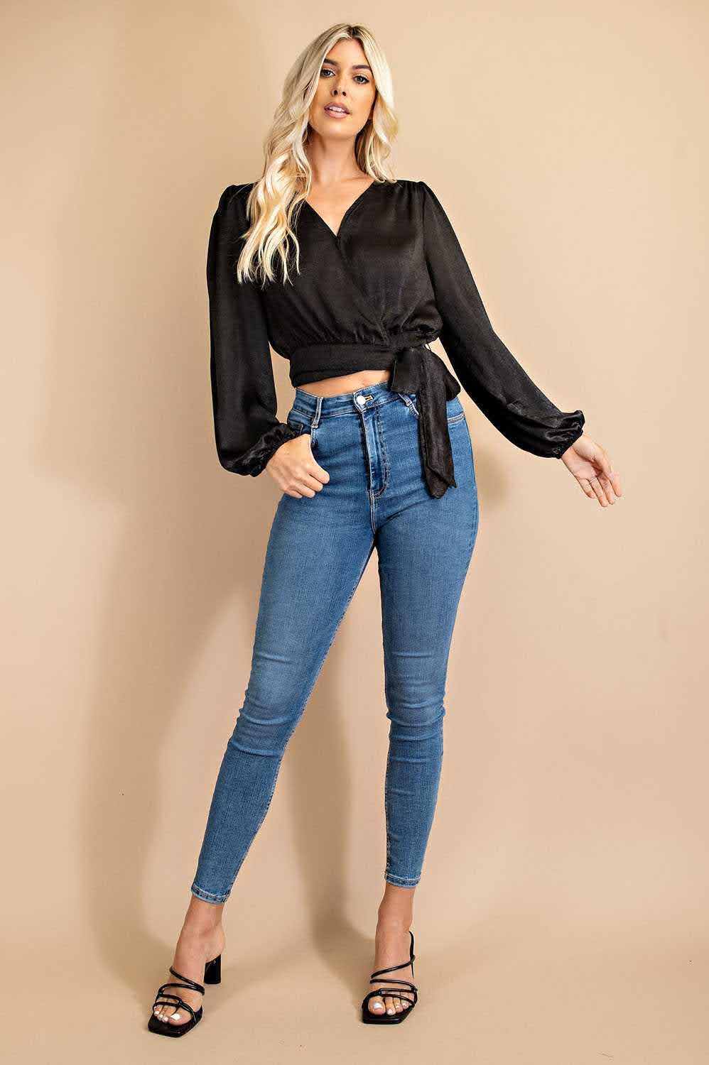 Effortlessly elevate your wardrobe with our Dina V-neck Front Tie Blouse in classic black. The snap button closure and 100% polyester fabric make it both stylish and comfortable, while the urban western, boho, cowgirl, and chic styles combine for a versatile and on-trend look. Embrace the boho-chic and bohemian vibes with this must-have piece. Model height: 5' 9".