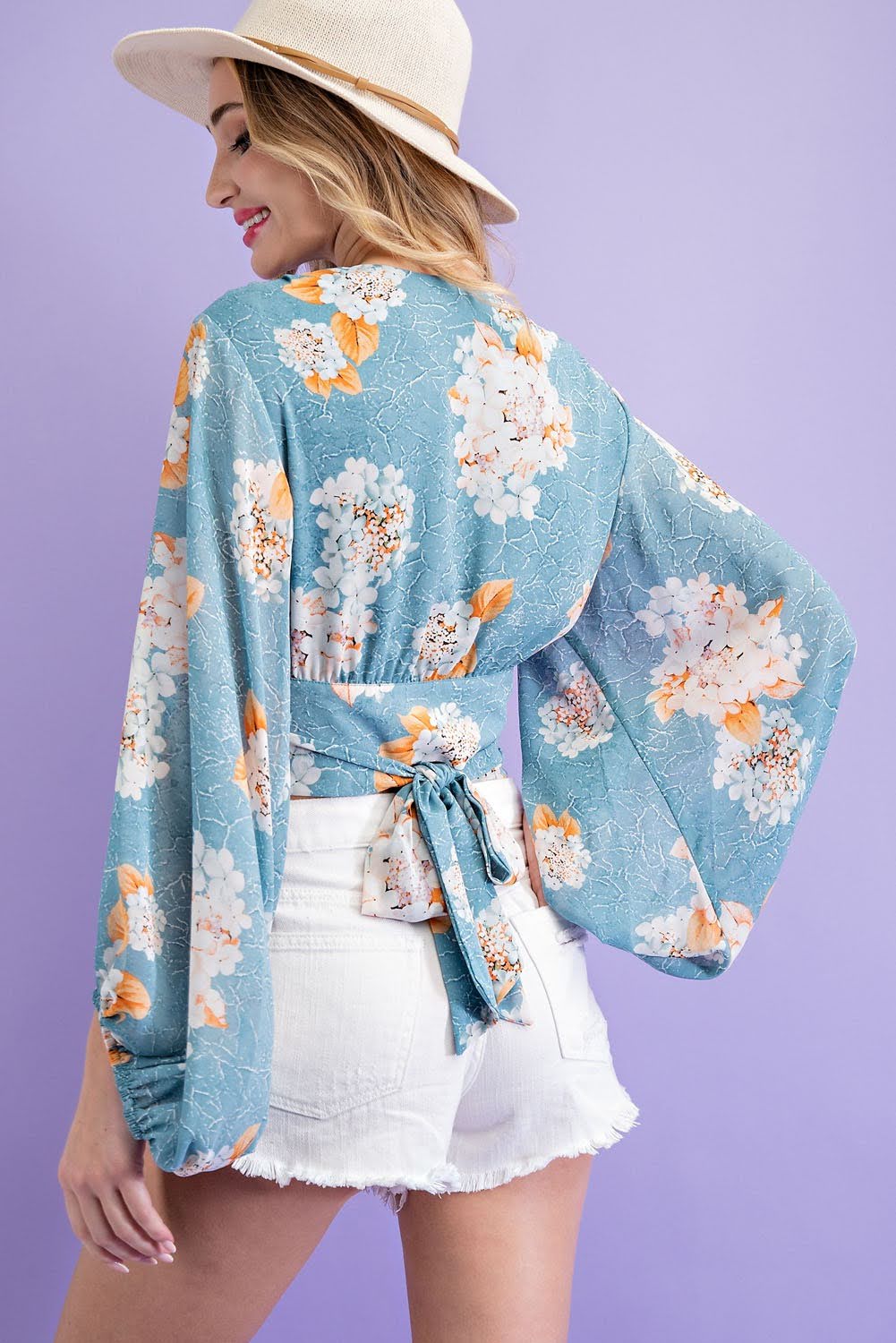 Elevate your wardrobe with our Flower Print Surplice Top! Made with a soft and flowy fabric, this blouse features a surplice neckline and adjustable tie for a flattering fit. Embrace the ultimate boho-chic style with this cropped long-sleeve top. Perfect for any occasion, this top will make you feel confident and stylish.