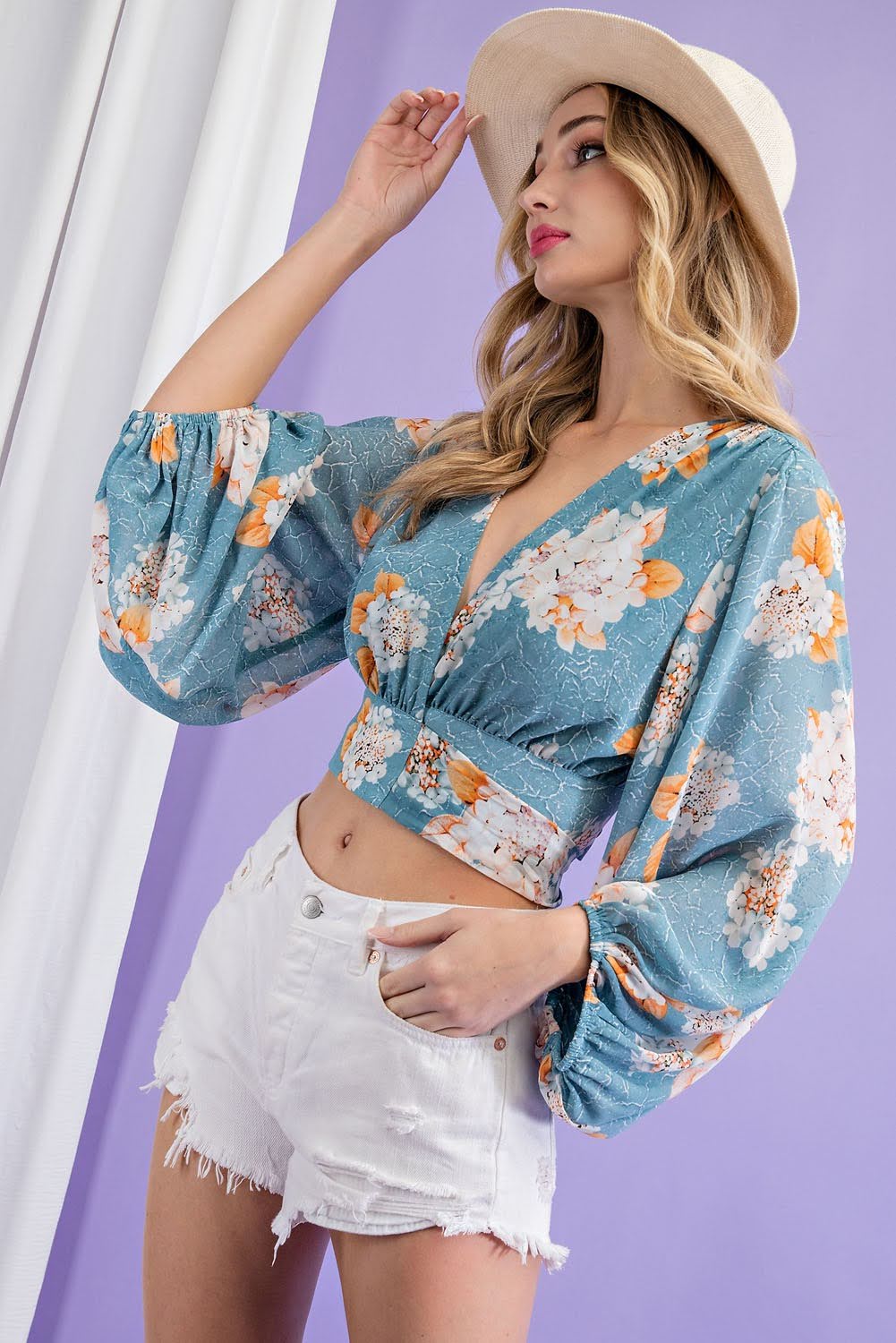 Elevate your wardrobe with our Flower Print Surplice Top! Made with a soft and flowy fabric, this blouse features a surplice neckline and adjustable tie for a flattering fit. Embrace the ultimate boho-chic style with this cropped long-sleeve top. Perfect for any occasion, this top will make you feel confident and stylish.