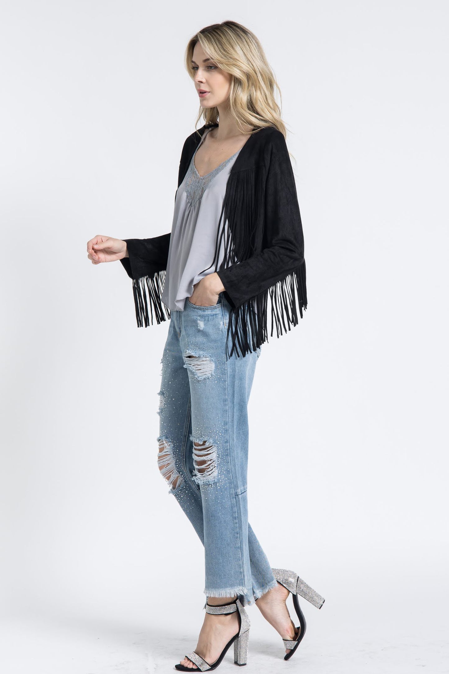 The Black Western Fringe Jacket from Vocal is the perfect addition to any wardrobe. Made with 96% poly and 4% spandex, this cropped jacket offers a chic and bohemian style with a touch of urban Western flair. Its versatile design makes it an essential piece for any cowgirl or fashion-forward woman.
