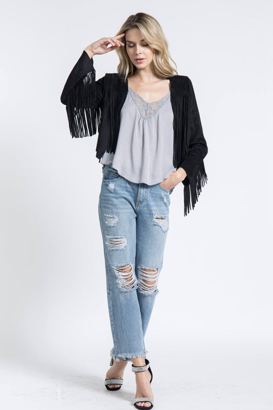 The Black Western Fringe Jacket from Vocal is the perfect addition to any wardrobe. Made with 96% poly and 4% spandex, this cropped jacket offers a chic and bohemian style with a touch of urban Western flair. Its versatile design makes it an essential piece for any cowgirl or fashion-forward woman.