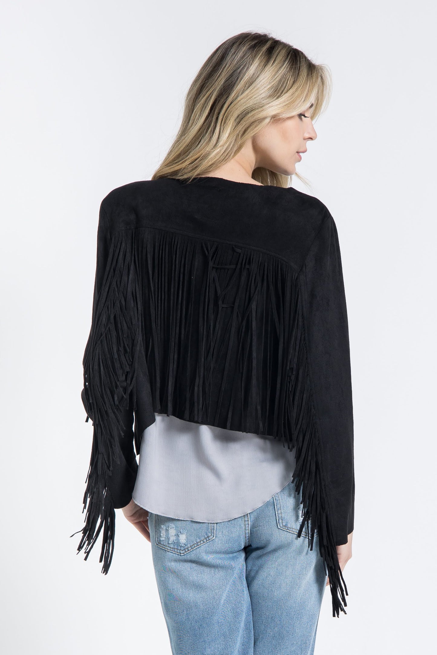 The Black Western Fringe Jacket from Vocal is the perfect addition to any wardrobe. Made with 96% poly and 4% spandex, this cropped jacket offers a chic and bohemian style with a touch of urban Western flair. Its versatile design makes it an essential piece for any cowgirl or fashion-forward woman.