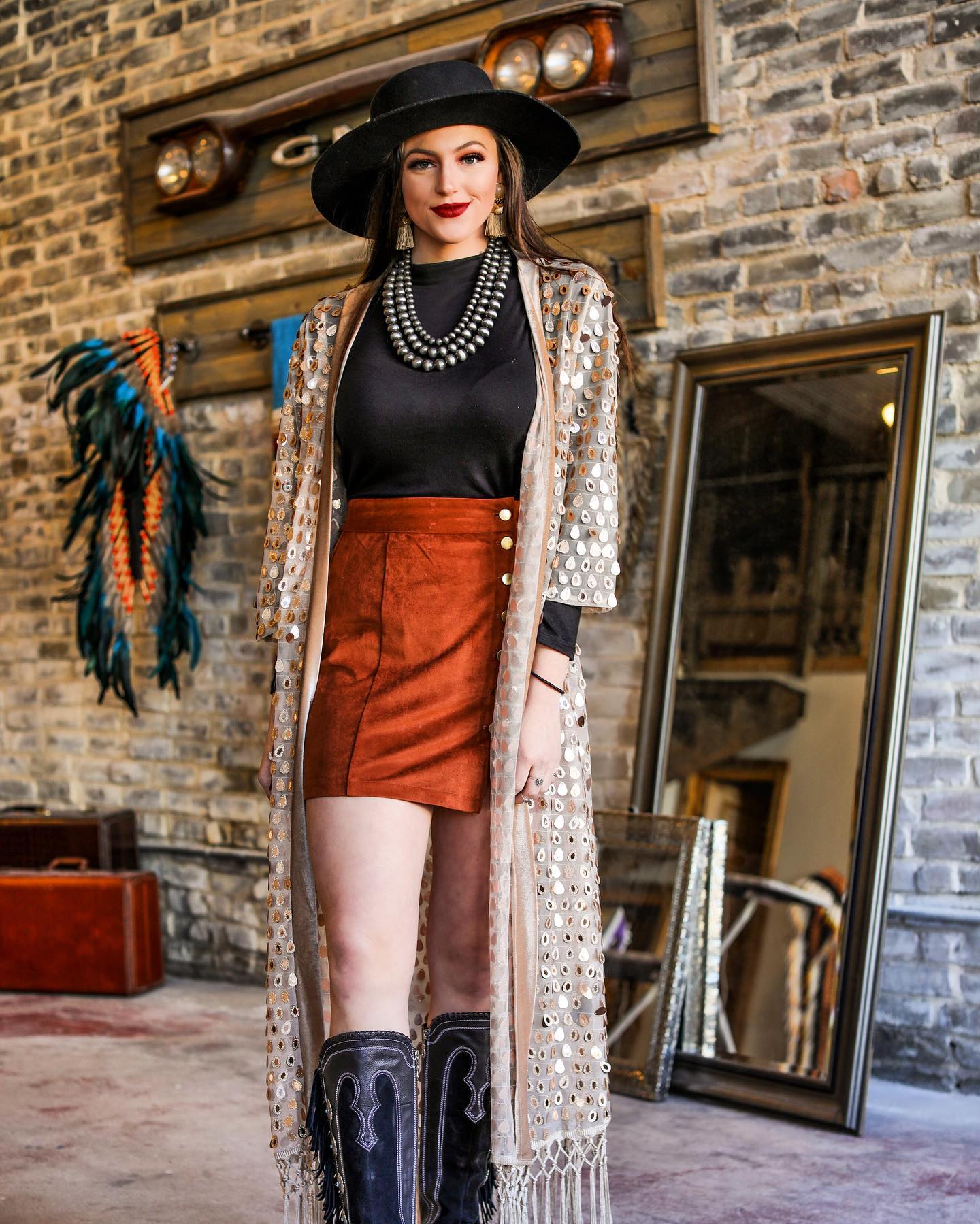Experience the perfect blend of chic and bohemian style with our Gold Sequin Kimono with Fringe. The versatile duster is made with a stunning gold color and features a long flowy silhouette adorned with delicate sequins and fringe detailing. Elevate your urban western or cowgirl look, adding a touch of western fashion to your wardrobe essentials.