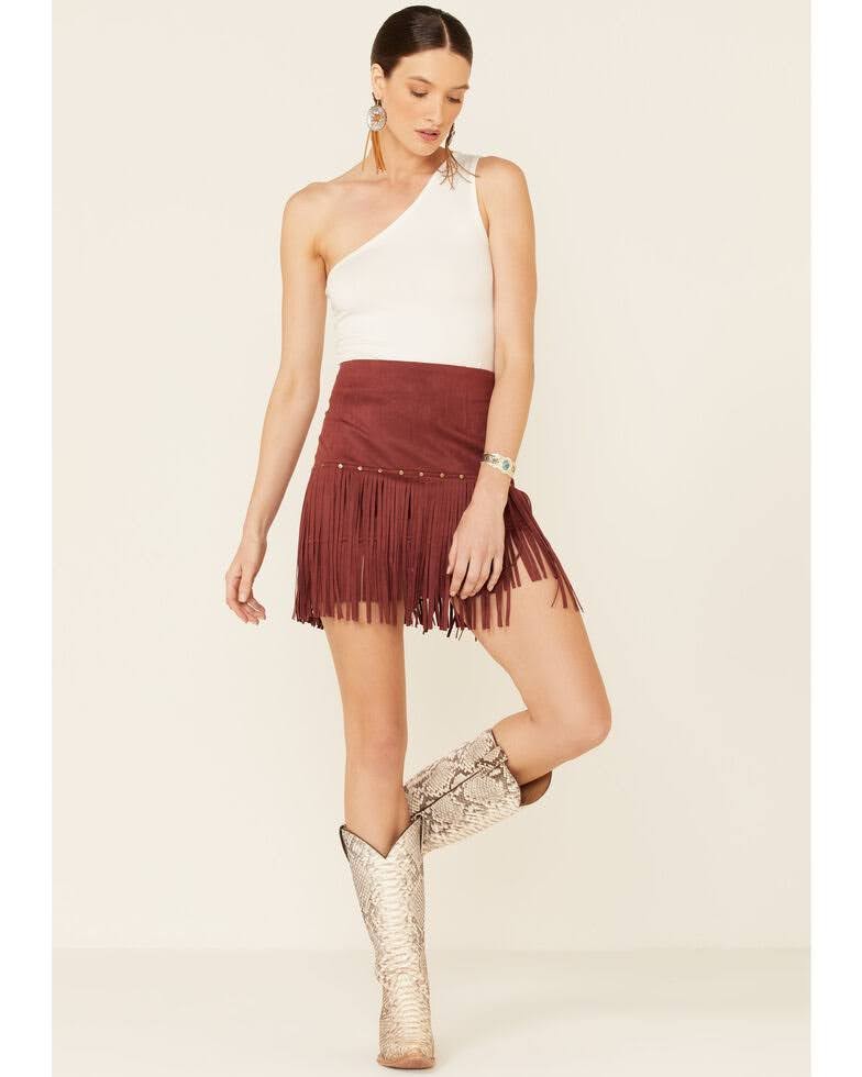 Get ready to turn heads with our Eliza Faux Suede Fringe & Studded Mini Skirt! Made with a soft, luxurious faux suede fabric, this skirt features gold-studded embellishments and a tiered style with fringe details. The zipper closure ensures a secure fit while the 87% polyurethane and 13% elastane blend provides comfortable stretch. Embrace your inner boho-chic cowgirl with this trendy mini skirt.