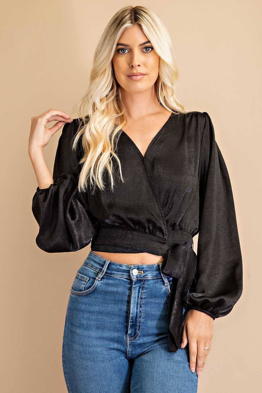 Effortlessly elevate your wardrobe with our Dina V-neck Front Tie Blouse in classic black. The snap button closure and 100% polyester fabric make it both stylish and comfortable, while the urban western, boho, cowgirl, and chic styles combine for a versatile and on-trend look. Embrace the boho-chic and bohemian vibes with this must-have piece. Model height: 5' 9".