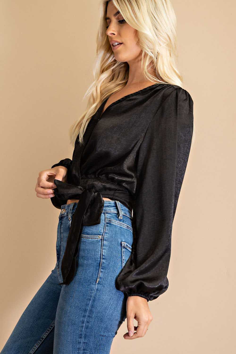 Effortlessly elevate your wardrobe with our Dina V-neck Front Tie Blouse in classic black. The snap button closure and 100% polyester fabric make it both stylish and comfortable, while the urban western, boho, cowgirl, and chic styles combine for a versatile and on-trend look. Embrace the boho-chic and bohemian vibes with this must-have piece. Model height: 5' 9".