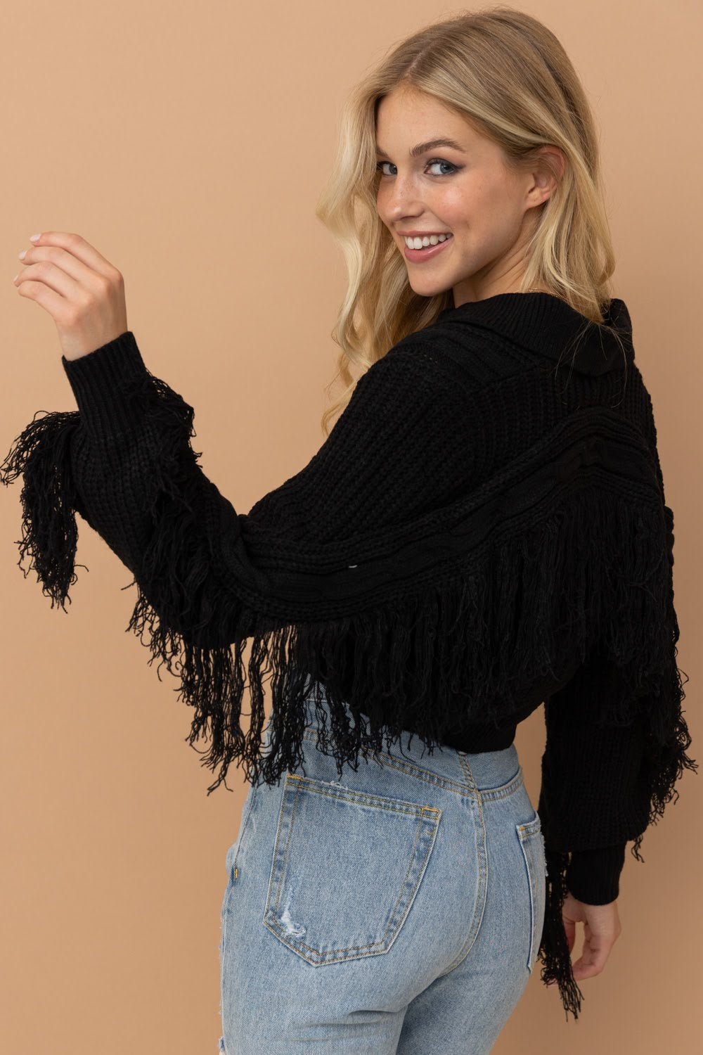 Elevate your wardrobe with the Crop Collared Fringe Sleeve Western Sweater by Blue B. Featuring a chic urban western, boho-cowgirl style, this sweater is perfect for adding a touch of boho-chic to any outfit. With its fringe detail, it adds a trendy and stylish element. Upgrade your look with this must-have sweater.