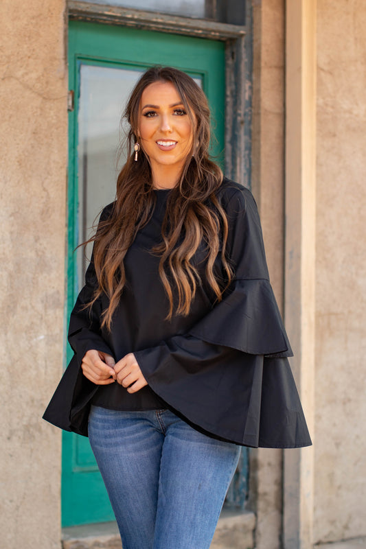Elevate your style with our Double Bell Long Sleeve Top - Black! Featuring a unique double bell sleeve design, this top combines urban western, boho, cowgirl, and chic styles for a one-of-a-kind look. Made of 65% polyester and 35% cotton, it's both comfortable and stylish. Perfect for adding a touch of boho-chic to any outfit.