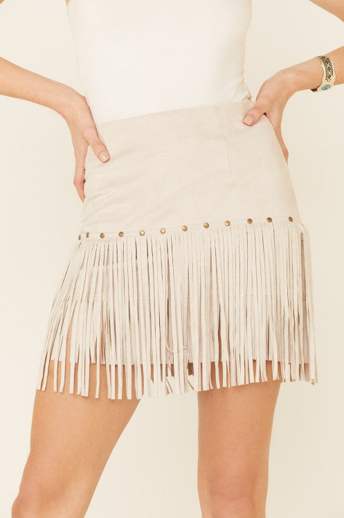 Channel your inner cowgirl with our Faith Faux Suede Fringe & Studded Mini Skirt. This luxurious piece features gold studded embellishments and a tiered style with fringe detail. Made with a blend of polyurethane and elastane, it offers both comfort and style. Perfect for adding a touch of urban western, boho, or bohemian flair to your chic wardrobe.