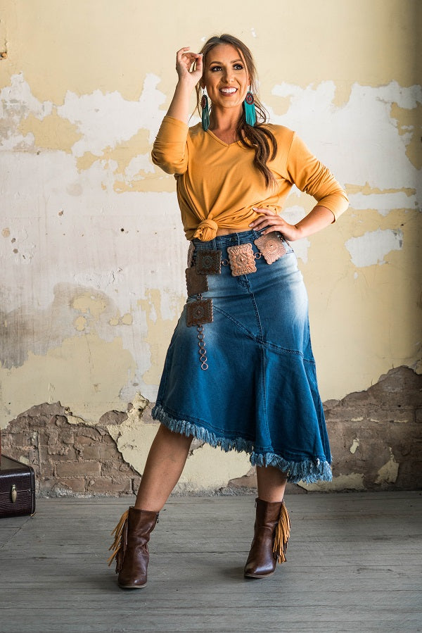 Elevate your style with our Denim High Rise Side Ruffle Midi Skirt! This stunning piece from Lucky and Blessed brand features a flattering high-rise design with a playful side ruffle and raw hem. Embrace the chic and unique with this must-have addition to your wardrobe!