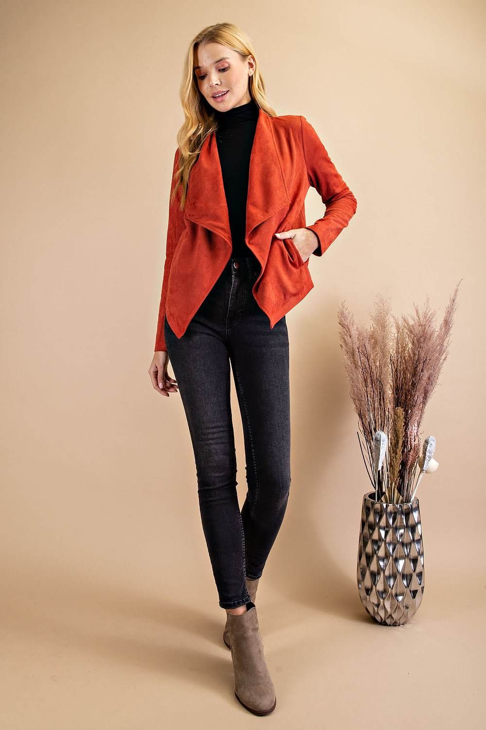 Expertly crafted with a wide collar and open front, the Danielle Suede Waterfall Blazer Jacket exudes boho-chic style. The 92% polyester and 8% spandex blend creates a comfortable yet chic fit, while the rhinestone fringe adds a touch of Western fashion. Complete any outfit with this essential bohemian piece.