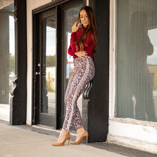 This leopard rhinestone fringe skinny jean is a statement piece that combines bold animal print with sparkling rhinestone details. With its slim fit, it flatters the figure while adding a touch of glamor. Perfect for those who want to stand out and make a stylish statement.